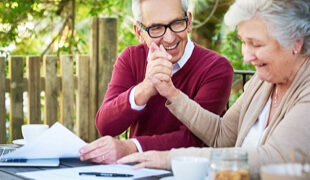 Older couple reviewing documents happily