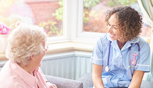 Nurse speaking with an older woman